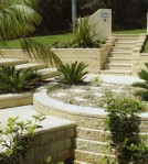 Stone faced concrete block retaining wall